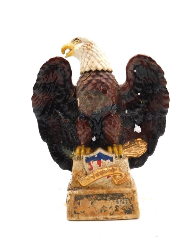 Eagle Rare No. 2 in a Series Eagle: A ceramic decanter cast as an eagle with wings spread in a commanding pose, marked Eagle Rare, No. 2 in a Series and 101 Proof to the base. The piece shows notable paint loss and chipping to the chest