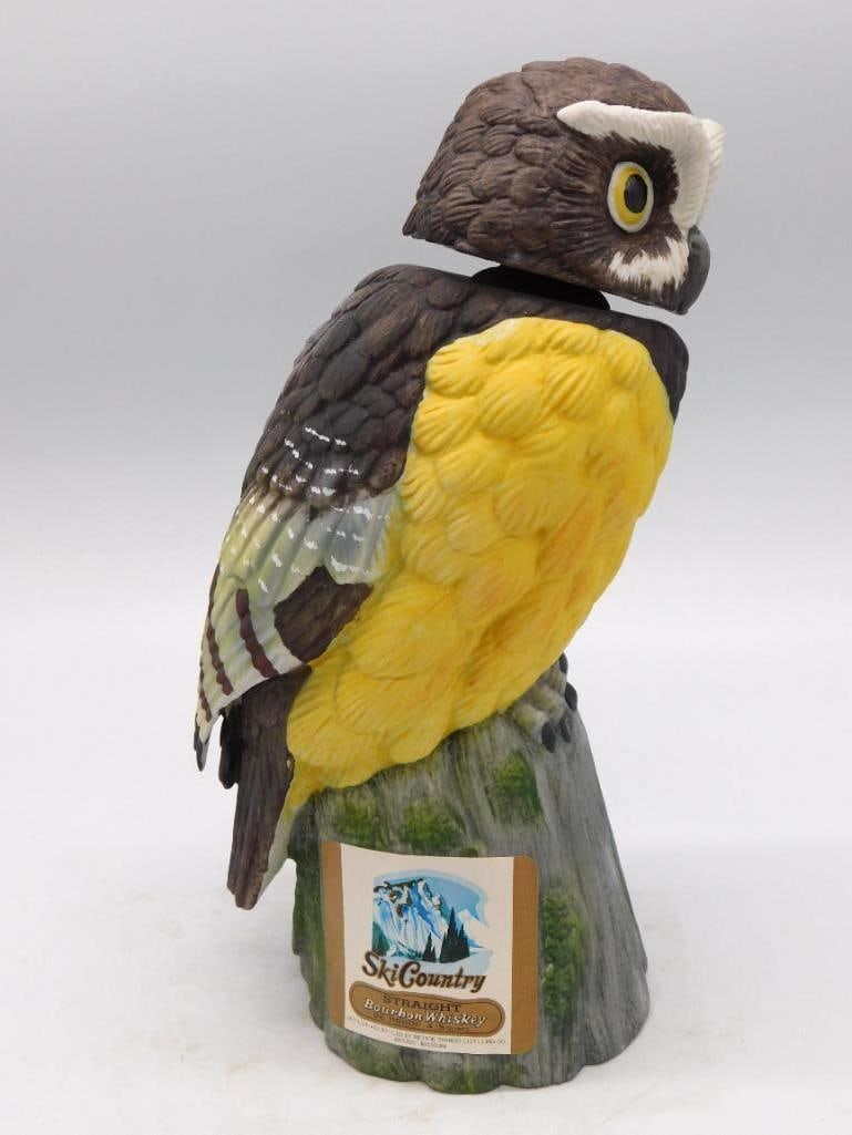 Crested Quail Porcelain Game Bird: A porcelain game bird decanter modeled as a crested quail-type bird with a yellow breast, perched upon a rock base, in the manner of the Ski Country bourbon decanter series. The plumage is nicely