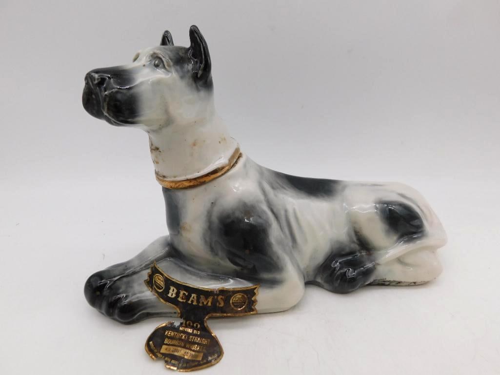 Jim Beam Great Dane Reclining Dog Regal: A fetching Jim Beam Regal China decanter modeled as a Great Dane at rest, ears pricked and head turned, coated in the black and white brindle of the breed with a gilt collar about the neck. A piece