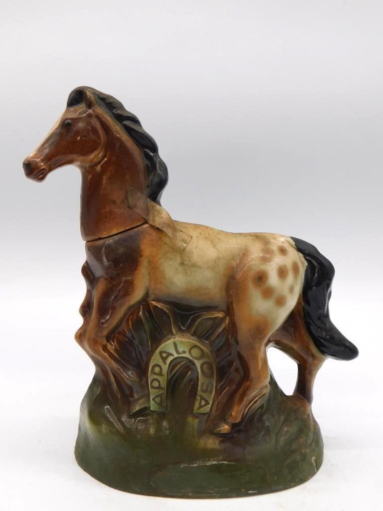 Rearing Appaloosa Horse Kentucky: A ceramic decanter modeled as a rearing spotted Appaloosa in brown and cream, standing upon an olive green base lettered Appaloosa. A spirited pose, and no small feat of the mold-maker's art. The piec