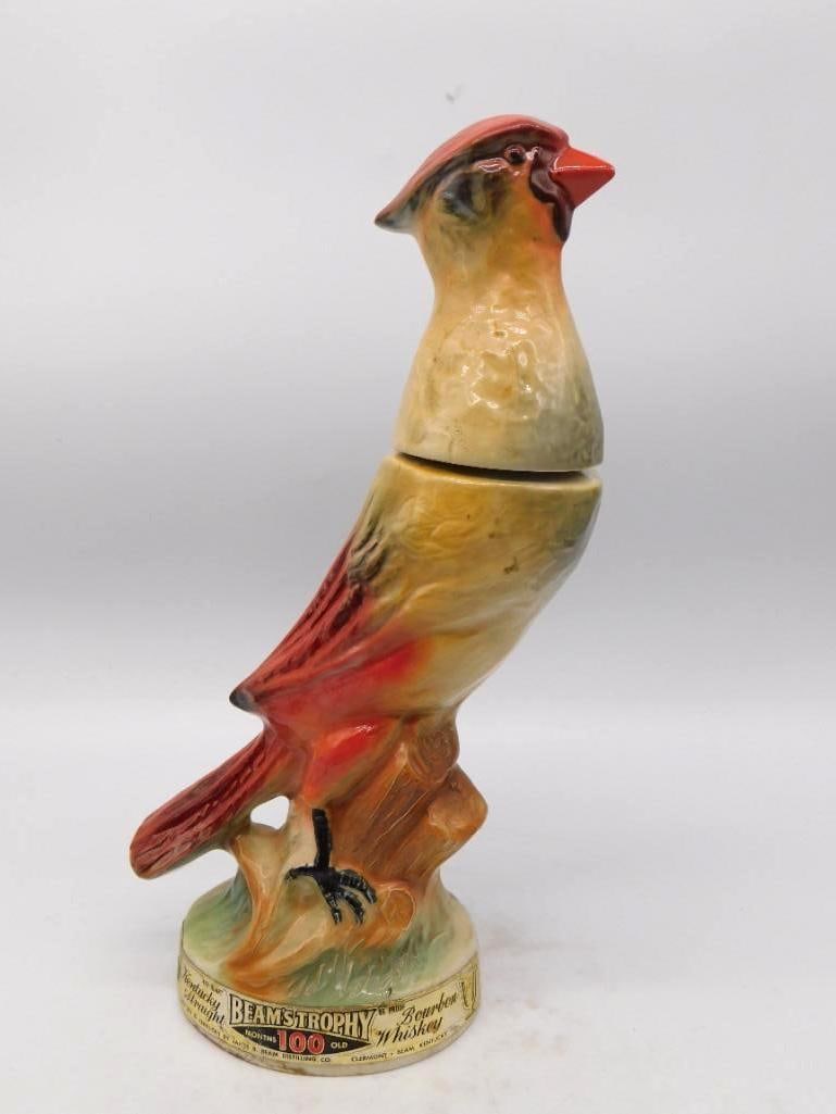 Jim Beam Trophy Cardinal Songbird: A Jim Beam Trophy decanter modeled as a cardinal perched upon a stump, head lifted and crest raised. The painter worked the plumage with a shrewd eye, carrying the red down the wing and tail against s