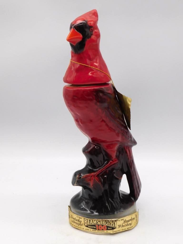 Jim Beam Beam's Trophy Cardinal Bird: A Jim Beam Regal China decanter from the Trophy series, modeled as a red cardinal perched upon a dark branch. The plumage is crisply sculpted and the red has kept its warmth. Marked Kentucky Straight
