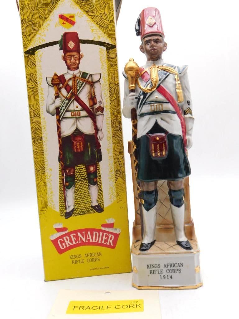 Grenadier Kings African Rifle Corps 1914: A Grenadier porcelain decanter sculpted as a soldier of the Kings African Rifle Corps, dated 1914, the uniform picked out with gilt detailing. Offered with its original box and a "Fragile Cork" tag.