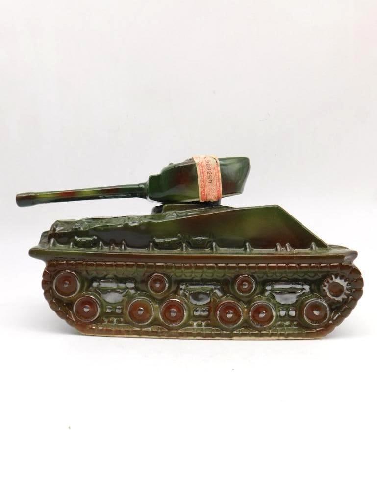 Ezra Brooks Military Tank Decanter, Ezra: A second Ezra Brooks decanter cast as an armored tank, glazed in olive and brown camouflage with the tread detail worked in relief. The Ezra Brooks 12 bourbon label appears at the turret. Sturdy and