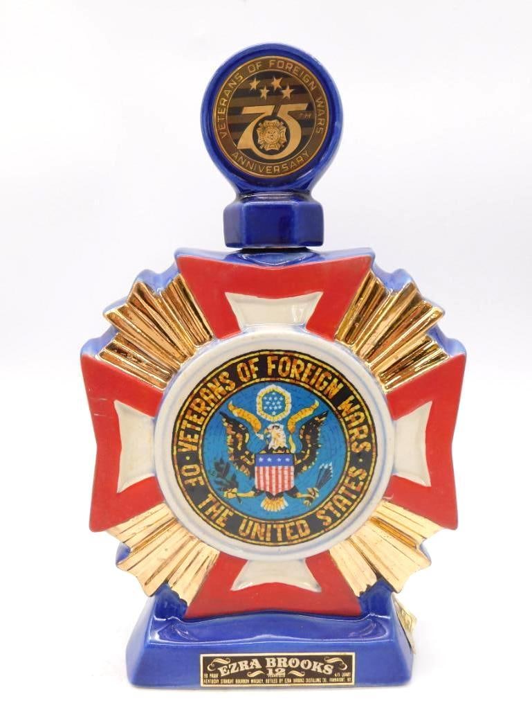 Ezra Brooks VFW 75th Anniv. Maltese: A ceramic decanter cast as a Maltese cross in blue and red glaze, struck for the 75th Anniversary of the Veterans of Foreign Wars of the United States. A sober and well-turned tribute, marked Ezra