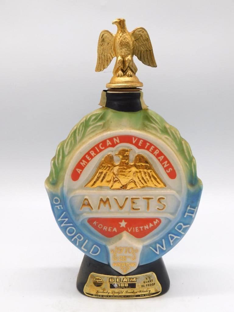 Jim Beam AMVETS 25th Anniv. Eagle: A ceramic Jim Beam decanter issued for the 25th Anniversary of AMVETS, American Veterans, noting Korea and Vietnam within a laurel-leaf border. The stopper is modeled as a gold eagle, a dignified