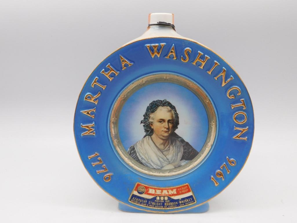 Jim Beam Martha Washington 1976: A round Jim Beam ceramic decanter struck in the plate form and cast with a portrait of Martha Washington against a field of blue. The relief lettering reads 1776 to 1976, marking the Bicentennial in