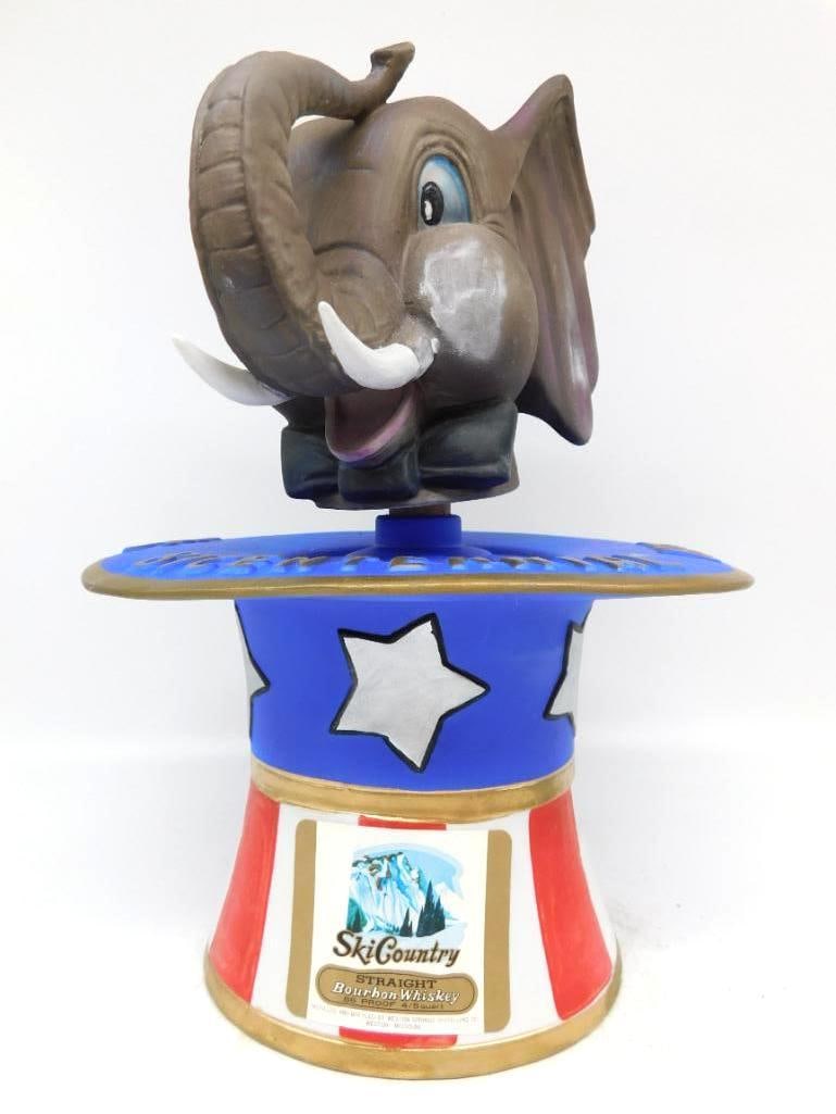 Ski Country Bicentennial 1776-1976: A Ski Country decanter modeled as an elephant's head rising from a star-spangled Uncle Sam top hat, the brim lettered Bicentennial 1776-1976 in gold. The hat is banded in blue with white stars above r