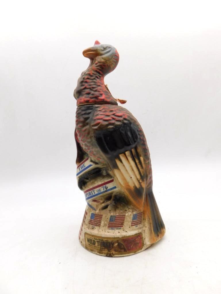 Wild Turkey Spirit of 76 Bicentennial: An Austin Nichols Wild Turkey decanter commemorating the American Bicentennial, titled The Spirit of 76, with painted flag banners circling the base. A hearty piece of patriotic shelf company. Good vi