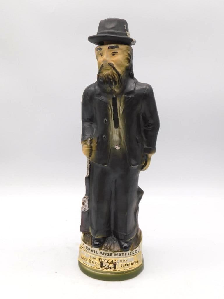 Jim Beam Devil Anse Hatfield Regal China: A Jim Beam Regal China decanter modeled as Devil Anse Hatfield, sober in black suit and hat. The sculptor caught a flinty bearing, and the paint has held its color admirably. The base is marked Devil