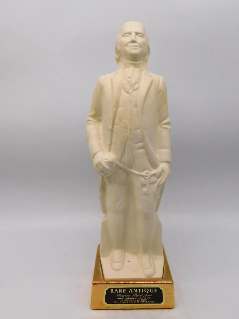 Rare Antique American Patriot Series: A tall milk-glass decanter modeled as Benjamin Franklin in frock coat and buckled shoes, spectacles held before him. The mold-maker caught the philosopher's shrewd and genial look without fuss, and