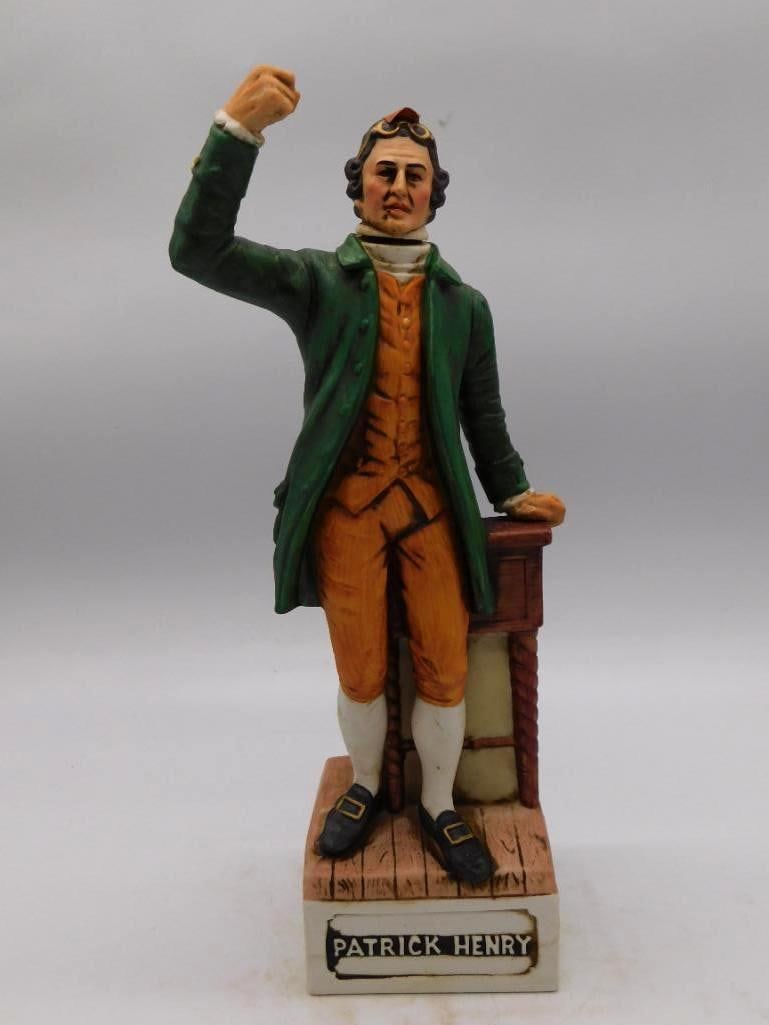 McCormick Patrick Henry Patriot Decanter: A McCormick ceramic decanter rendered as the patriot Patrick Henry in a green coat and orange breeches, standing beside his lectern, the name Patrick Henry set out on the base plaque. The McCormick