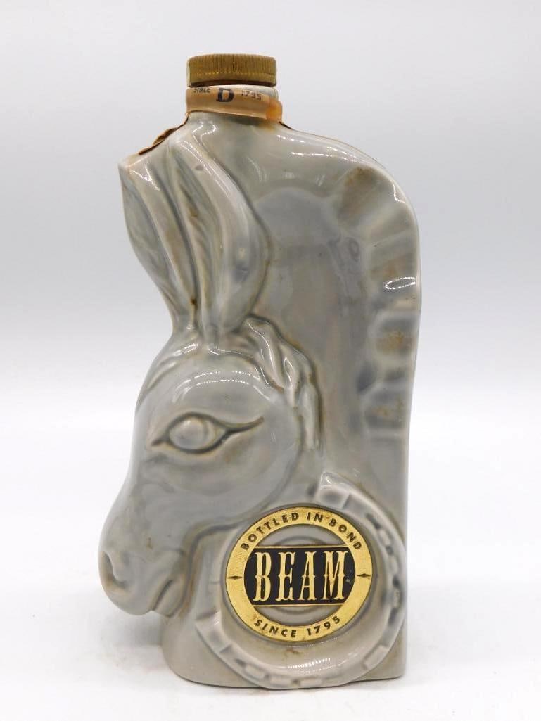Jim Beam GOP Elephant Bottled-in-Bond: An early gray ceramic Jim Beam decanter cast as the Republican Party elephant, marked Bottled in Bond, Beam Since 1795. It carries orange Internal Revenue tax stamps dated April 1956, which is no