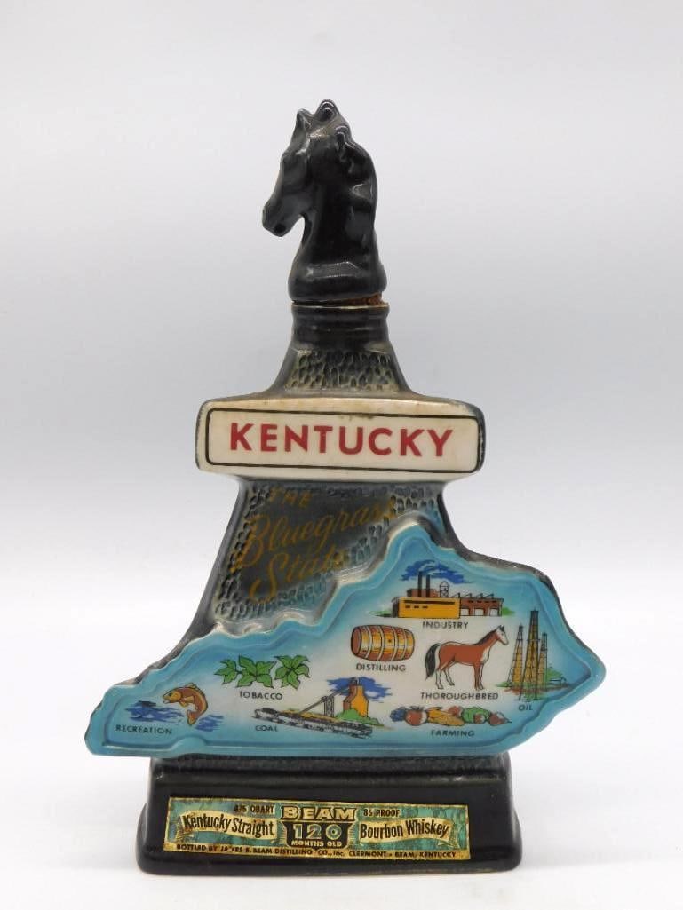 Jim Beam Kentucky Bluegrass State Chess: A Jim Beam ceramic decanter topped with a black chess-knight horse head, the body embossed with a map of Kentucky and the industries of the state. Labeled 'Beam 120 Months Old Kentucky Straight Bourbo