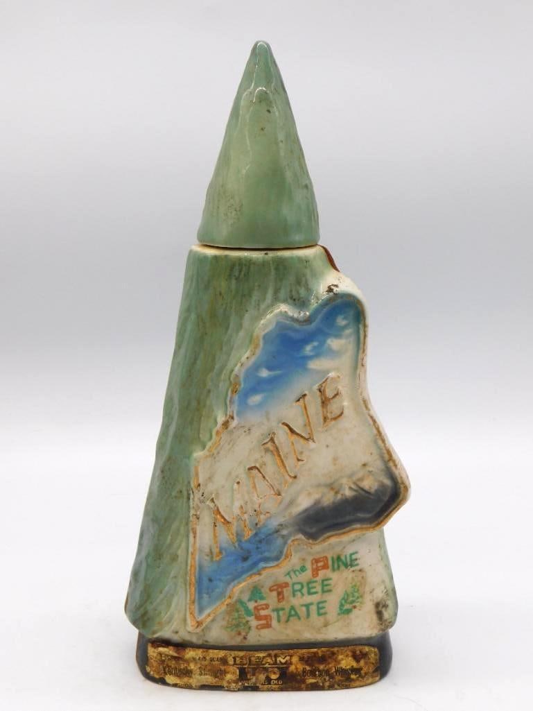 Jim Beam Maine Pine Tree State Regal: A Jim Beam Regal China decanter shaped as an evergreen with a raised map of Maine, "The Pine Tree State." A trim souvenir of the northern woods for the collector working the state series. The