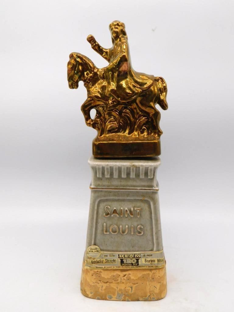 Jim Beam Saint Louis Equestrian Statue: A Jim Beam Regal China decanter after the mounted statue that stands in Saint Louis, the rider and horse cast in bright gold luster above a gray pedestal lettered SAINT LOUIS and set with a horseshoe