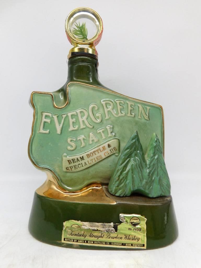 Jim Beam Evergreen State Washington: A handsome Jim Beam decanter shaped as the state of Washington in shaded greens, lettered Evergreen State above a Beam Bottle & Specialties Club banner, with a pair of modeled firs standing at the sid