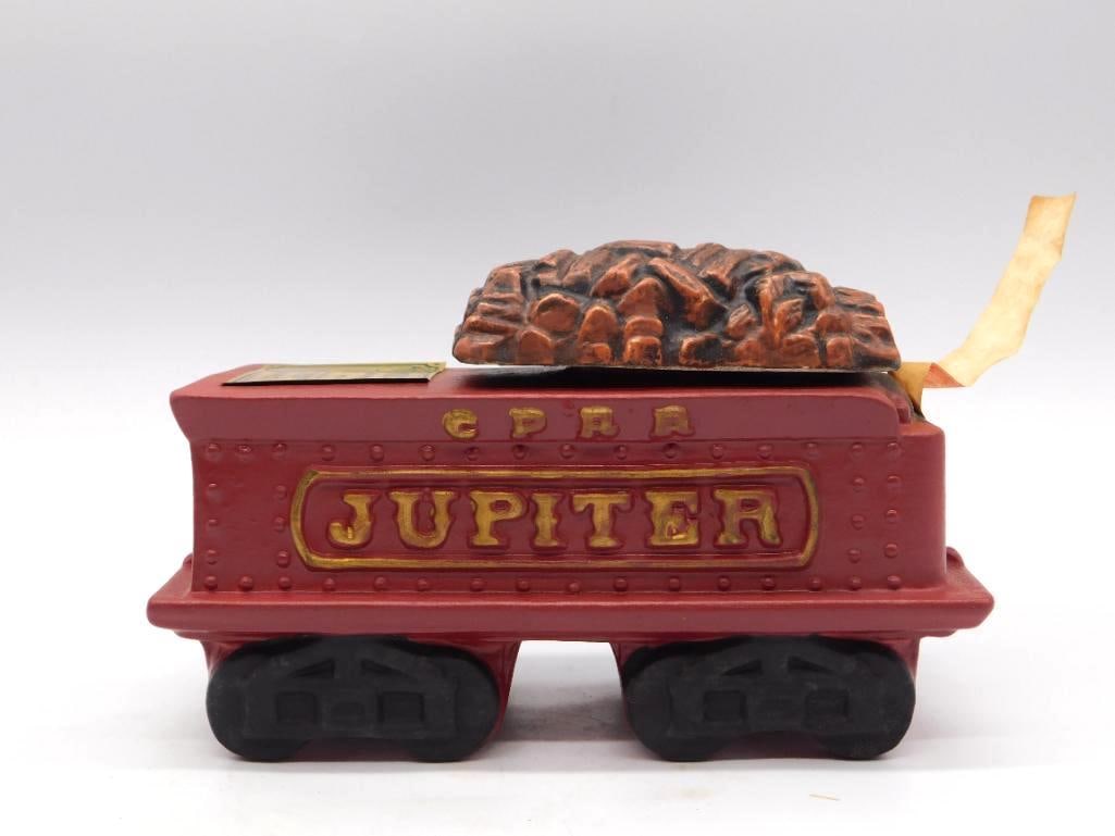 McCormick Jupiter CPRR Locomotive Tender: A McCormick Distilling Co. limited edition decanter cast as the tender car of the Jupiter, that storied Central Pacific locomotive, in red with gold lettering and a removable coal-load lid. Straight