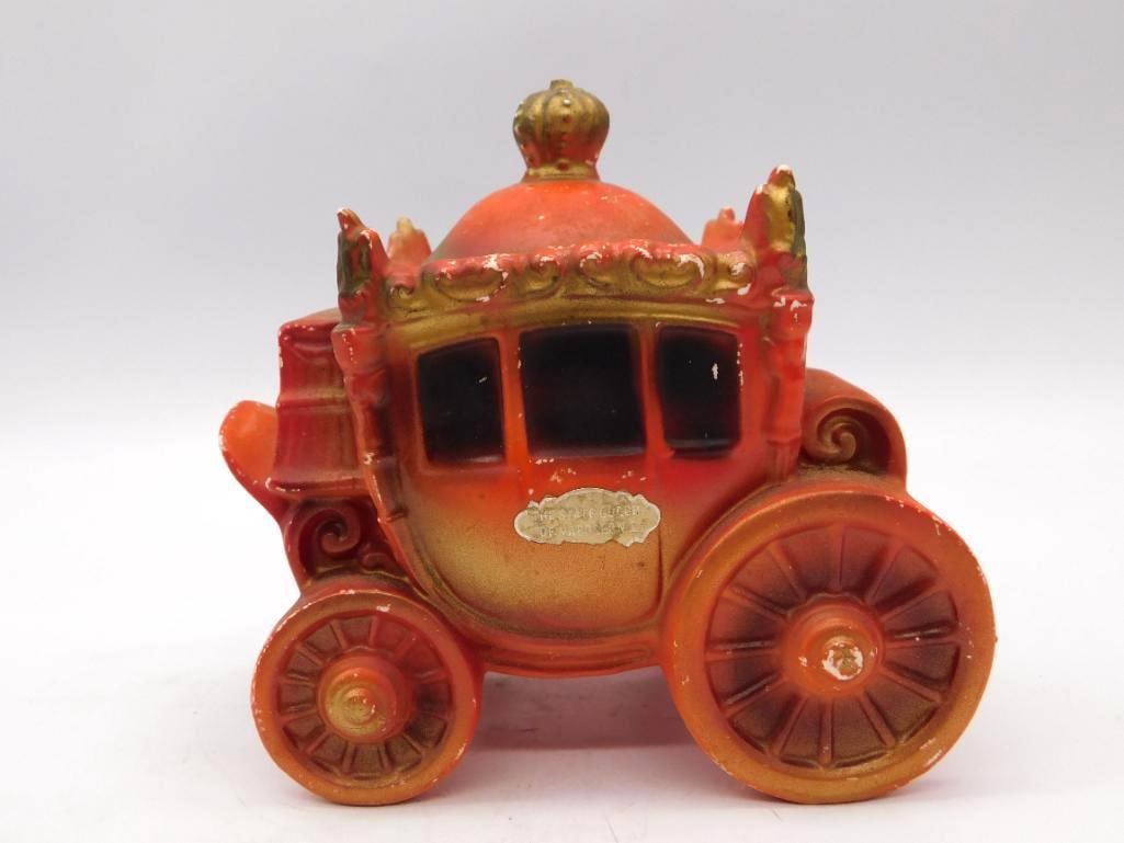State Coach of Napoleon I Ceramic: A decorative ceramic decanter cast as a royal state coach in orange and gilt, crowned with a finial and bearing a small plaque reading THE STATE COACH OF NAPOLEON I. Approximately 7 inches tall. Some