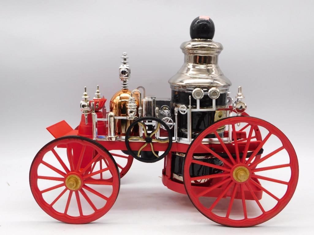 Jim Beam 1867 Mississippi Steam Fire: A Jim Beam Regal China decanter modeled after the 1867 Mississippi steam fire engine, handsome with its chrome-tone boiler and red wheels, and no small feat of the mold-maker's art. Comes with the
