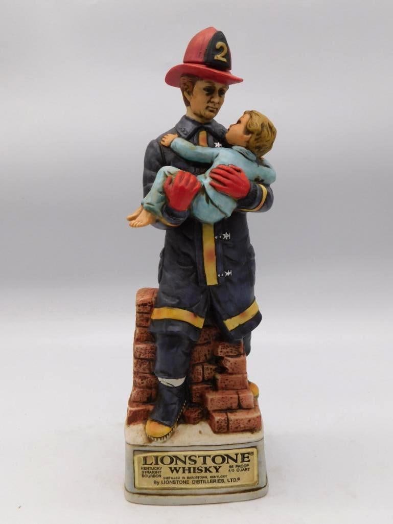 Lionstone In the Line of Duty Fireman: A Lionstone Distilleries decanter titled In the Line of Duty, sculpted as a fireman carrying a rescued child clear of a brick building. A descriptive plaque is set into the base. Stands approximately