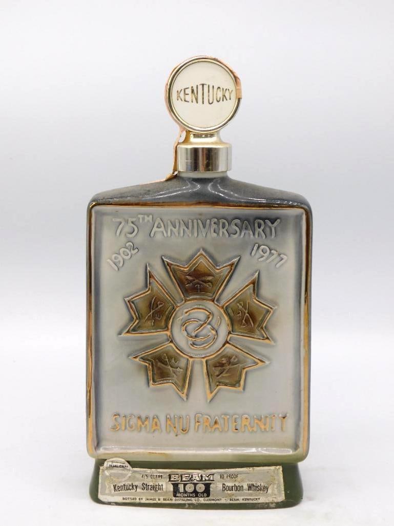 Jim Beam Sigma Nu Fraternity 75th Anniv.: A dignified Jim Beam decanter in smoke gray and gilt, the front molded in relief with the Sigma Nu star and serpent above the legend 75th Anniversary 1902-1977, the reverse lettered Gamma Iota