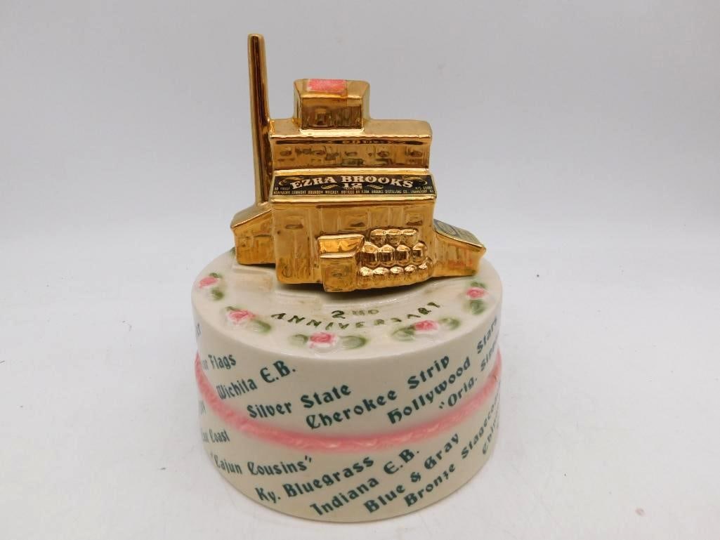 Ezra Brooks 2nd Anniv. Riverboat: An agreeable Ezra Brooks decanter marking the club's second anniversary, a gold sternwheeler riding atop a molded anniversary cake ringed with painted roses. The cake bands are lettered with chapter n