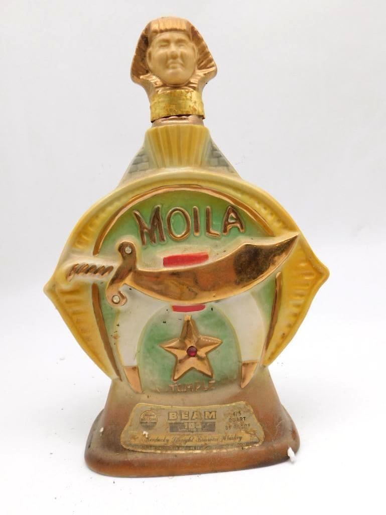 Jim Beam Moila Shrine Temple Regal China: A Jim Beam Regal China decanter commemorating the Moila Shrine Temple, topped with a gold-tone Egyptian Sphinx head stopper. The applied scimitar, crescent, and star emblem is smartly done. The