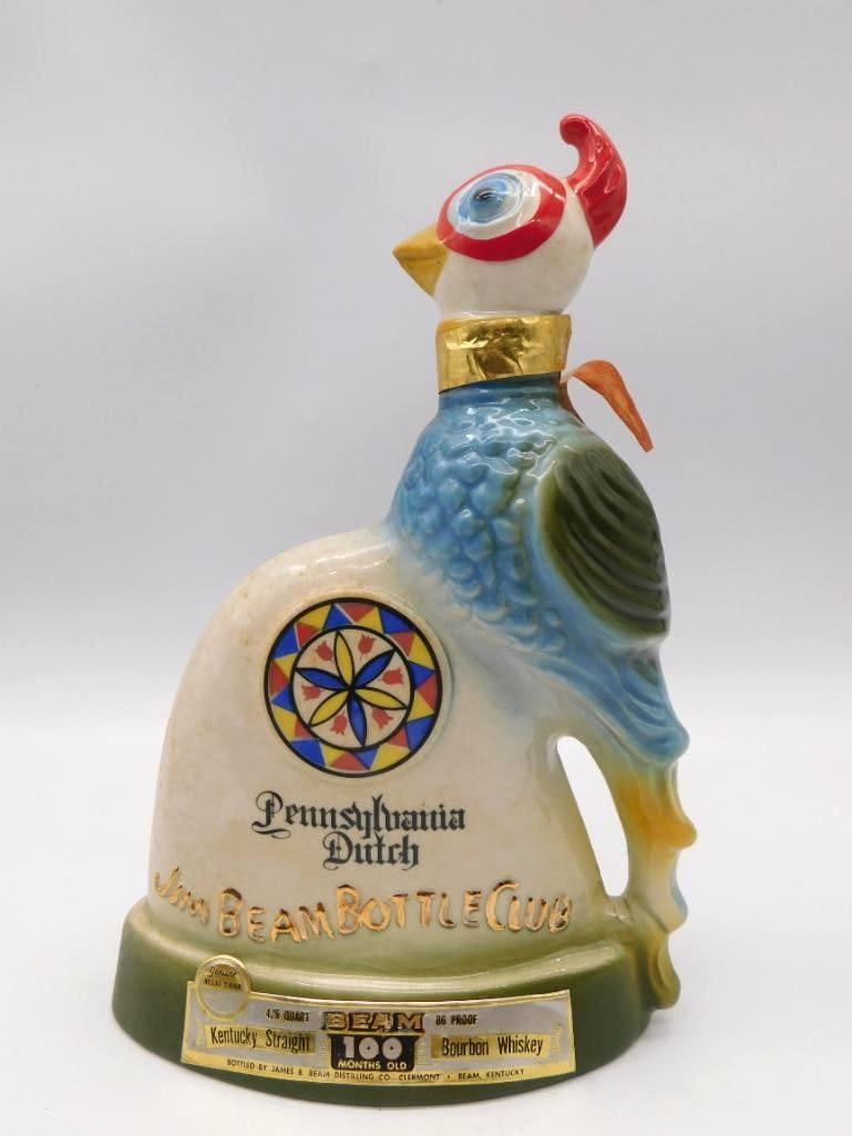 Jim Beam Pennsylvania Dutch Bottle Club: A jaunty Regal China decanter in the form of a rooster, his plumage bright and a hex sign worked upon the body alongside the Pennsylvania Dutch Jim Beam Bottle Club marking. Approximately 11 inches ta