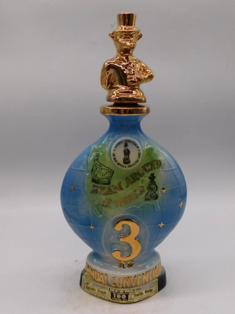Jim Beam Club 3rd Annual Convention: A ceramic Jim Beam club decanter with globe-form body, commemorating the 3rd Annual Convention held at Detroit in July 1973, finished with a gold sculpted stopper. Marked Kentucky Straight Bourbon