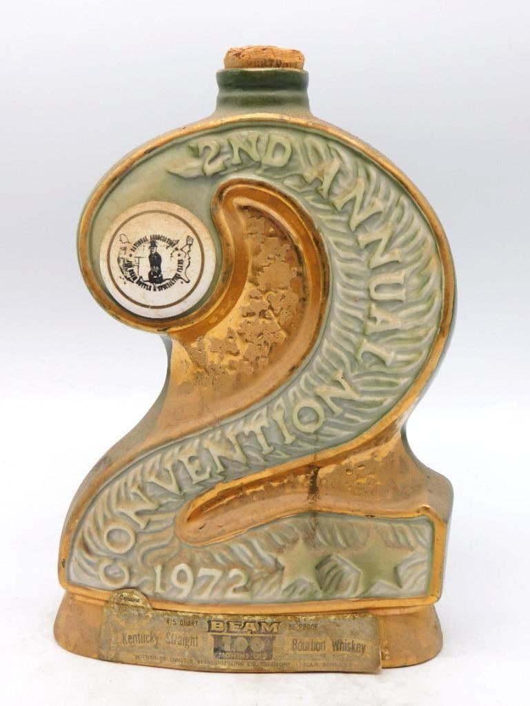 Jim Beam 2nd Annual Convention 1972: A Jim Beam decanter cast as a large numeral two for the 2nd Annual Convention of the National Association of Jim Beam Bottle and Specialties Clubs, hosted at Anaheim in June of 1972. Gold and pale gre