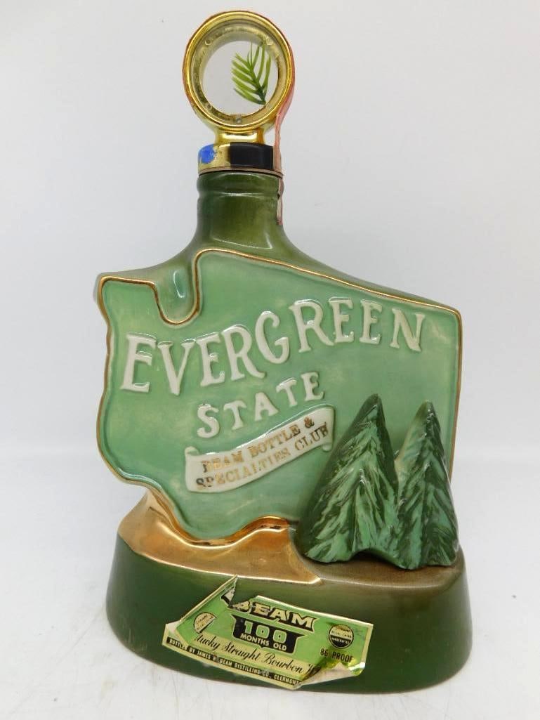 Jim Beam Evergreen State Washington Beam: A Jim Beam decanter cast in the outline of Washington, lettered EVERGREEN STATE above a banner for the Beam Bottle and Specialties Club, with two modeled firs standing at the right. The green glaze