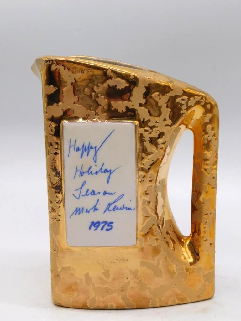 Jim Beam Bottle and Specialties Clubs: A gold-glazed ceramic handled jug struck for an annual convention of the International Association of Jim Beam Bottle and Specialties Clubs. The underside carries a personal inscription, Happy Holiday