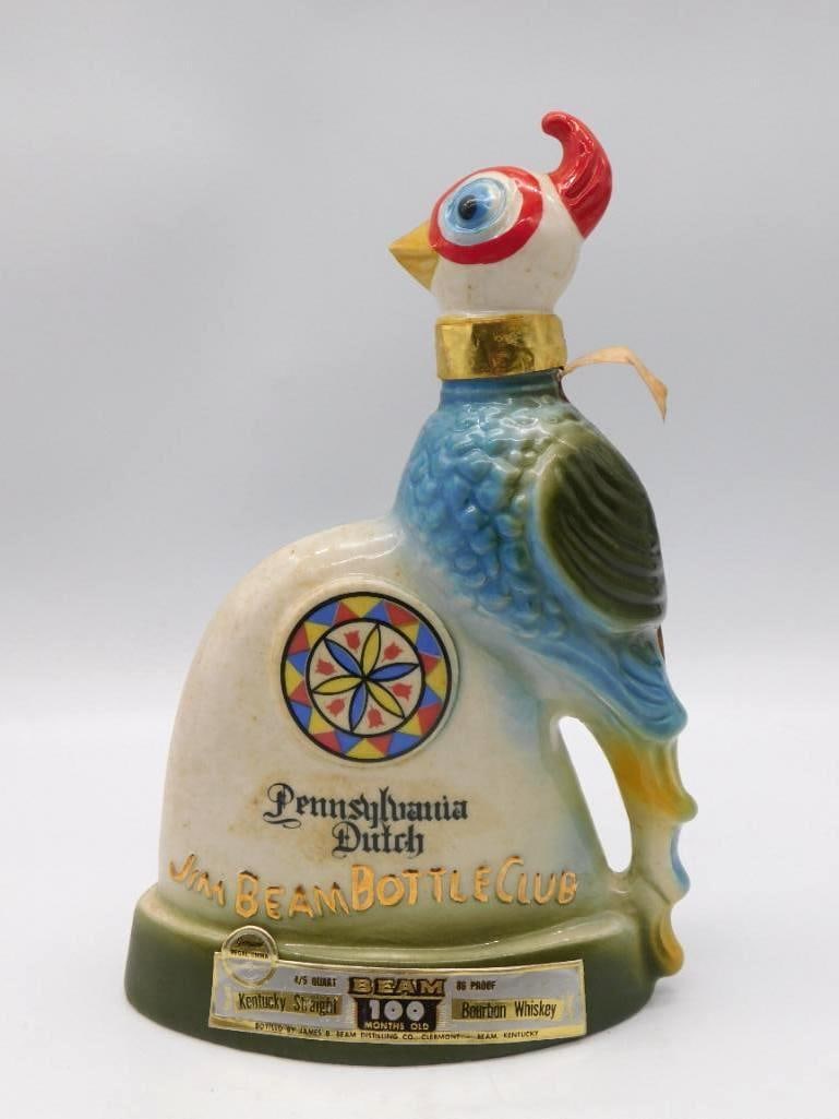 Jim Beam Regal China Pennsylvania Dutch: A lively Regal China decanter in the form of a rooster in full color, his body carrying a hex-sign design and the Pennsylvania Dutch Jim Beam Bottle Club marking. Homespun and handsome, the sort of pi