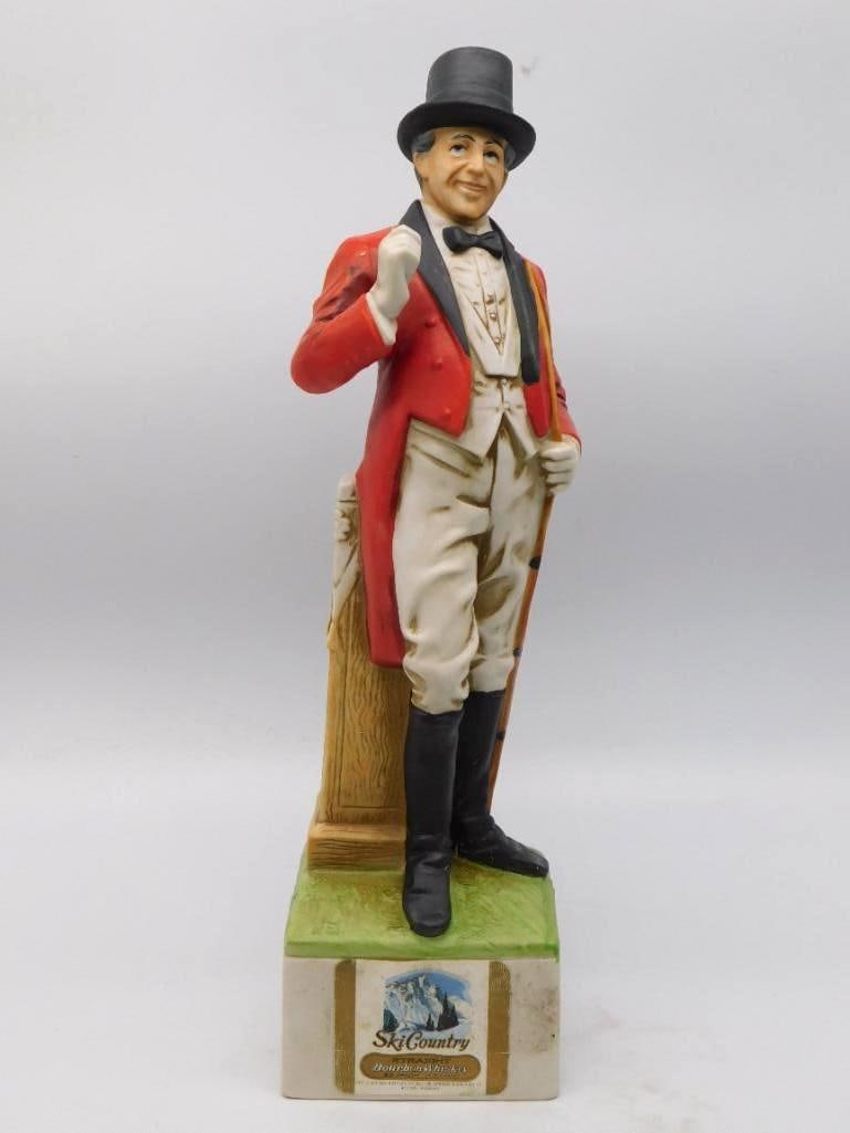 Ski Country Barnum Festival Ringmaster: A Ski Country decanter modeled as a Barnum Festival ringmaster in scarlet tailcoat and top hat, cane in hand and a knowing look about him. The bisque is crisply cut and the painting careful, down to