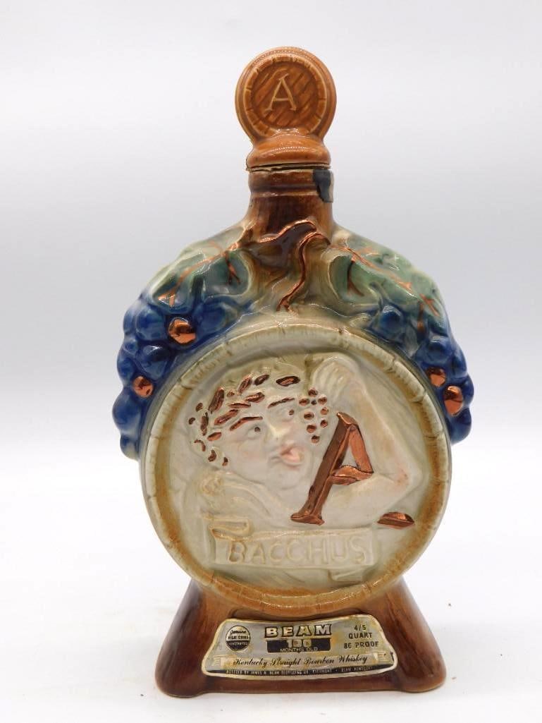Jim Beam Bacchus Grapevine Regal China: A Jim Beam Regal China decanter bearing a relief bust of Bacchus upon a barrel-form body, the grapevine detail worked in blue and green against copper luster. This is the second such example in the