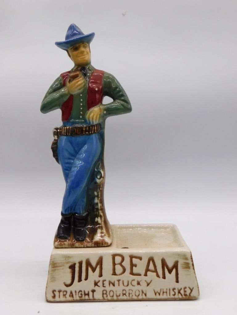 Jim Beam Trooper Beam Bourbon Since 1795: A Jim Beam Regal China decanter sculpted as a trooper in the mounted-police manner, trim in a green and red uniform with blue jodhpurs and knee-high boots. The base reads Jim Beam Kentucky Straight