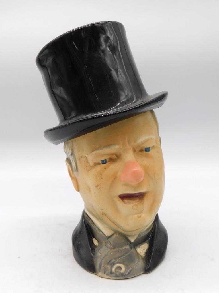 W.C. Fields Style Top-Hatted Character: A ceramic character decanter modeled as a top-hatted gentleman in the manner of W.C. Fields, jowls and hat and all. A genial fellow to keep upon a shelf. Please see photos for exact size, maker
