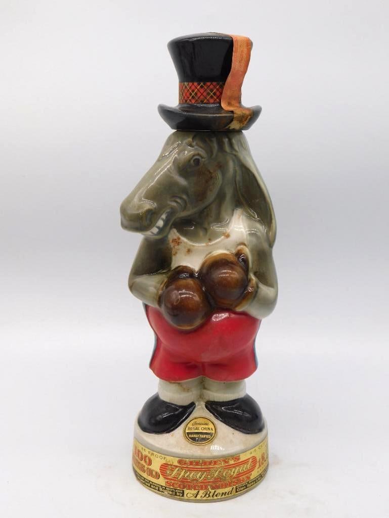 Gilbey's Spey Royal Boxing Horse Regal: A genial Regal China decanter modeled as a horse squared up in boxing gloves, red trunks and high collar, with a plaid-banded top hat serving as the stopper. The sculptor caught a comic dignity in
