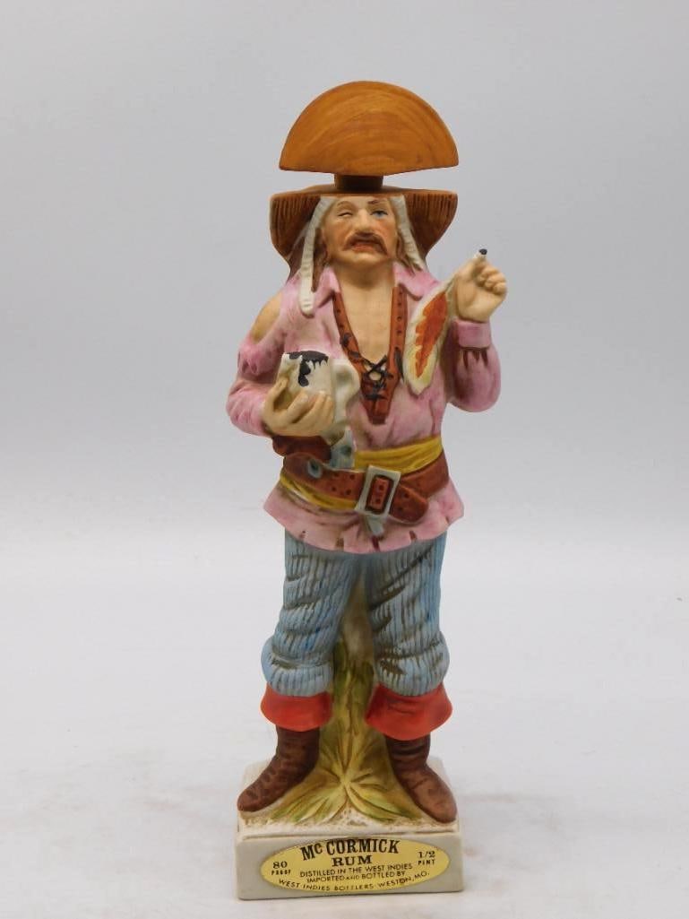 McCormick Rum Buccaneer Decanter, West: A spirited McCormick decanter modeled as a buccaneer in a broad plumed hat, tankard in hand and a stout belt at his waist. The painter worked in cheerful pinks and blues, and the modeling of the