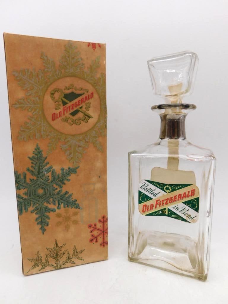 Old Fitzgerald Bottled in Bond Glass: A trim square glass decanter of Old Fitzgerald, bottled in bond, with silvered collar and a heavy faceted glass stopper. The front label reads Kentucky Straight Bourbon Whiskey, 100 proof, 6 years
