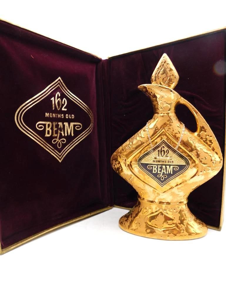 Jim Beam 162 Months Old Gold Ewer: A handsome Jim Beam Regal China decanter of textured all-gold ewer form, marked 162 Months Old Beam upon the bottle medallion and again within the matching hinged burgundy presentation box. A