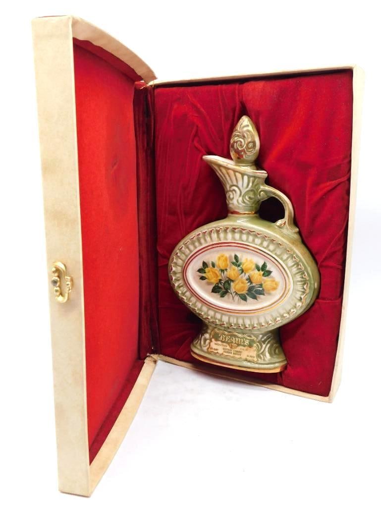 Jim Beam Regal China Yellow Rose Ewer: A capital Jim Beam Regal China ewer in soft green and gold, its oval face painted with a spray of yellow roses within a pierced and gilded border. The scrolled handle and flame-form stopper are
