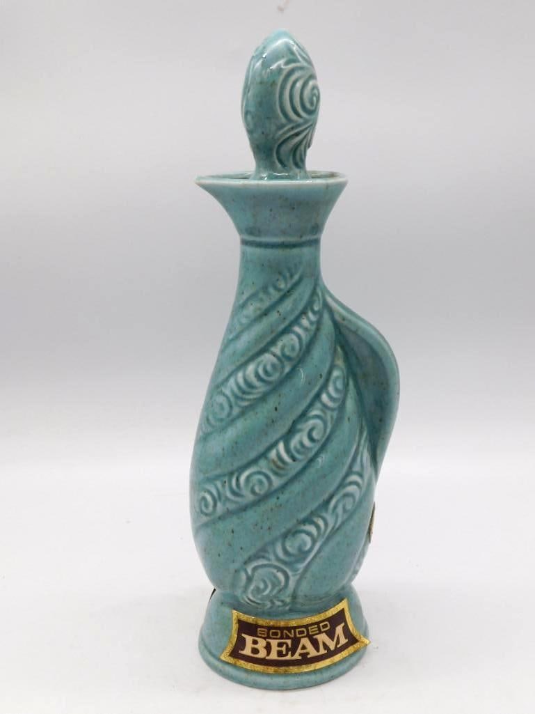 Jim Beam Bonded Beam Executive Series: A Jim Beam Regal China decanter from the Executive series, turned in a turquoise swirl pattern with a matching stopper. Marked "Bonded Beam" on a gilt label at the base. A clean and decorative mid-cen