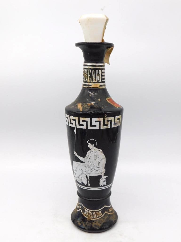 Jim Beam Black Grecian Urn Decanter with: A well-turned Jim Beam urn in glossy black, its body banded with a Greek key border and a seated classical figure with spear and helmet in white and silver. A piece with genuine presence on a shelf,