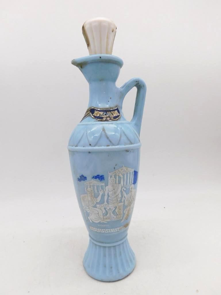 Jim Beam Blue Grecian Ewer Decanter with: A Jim Beam ewer in pale Grecian blue, the body printed in white with a classical scene captioned Socrates before a temple colonnade. A looped handle, Greek key border and fluted pedestal foot give it