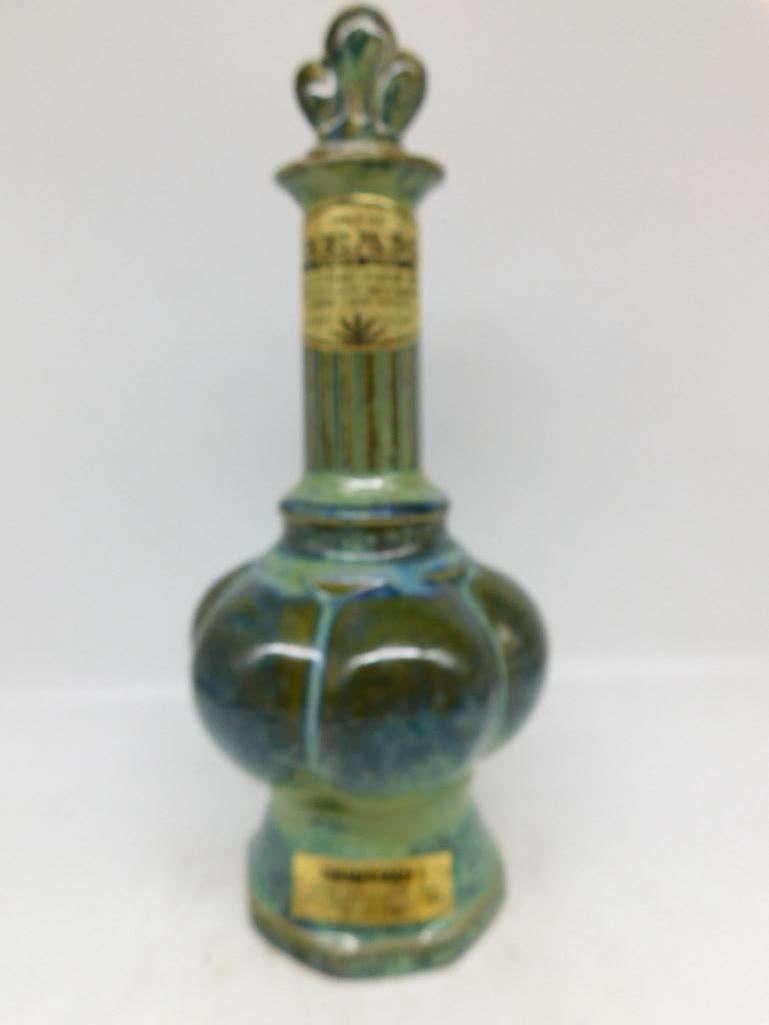 Jim Beam Regal China Green Mottled Glaze: A stately Jim Beam decanter under a mottled green and blue drip glaze, the lobed melon body rising to a fluted neck and finished with a scrolled crown stopper. The glaze pooled handsomely in the
