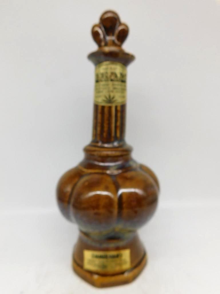 Jim Beam Brown Glazed Crown Stopper: A well-turned Jim Beam decanter with a deep lobed body and slender fluted neck, glazed in warm amber and brown with darker mottling at the shoulder and foot. The crown-form stopper is a handsome