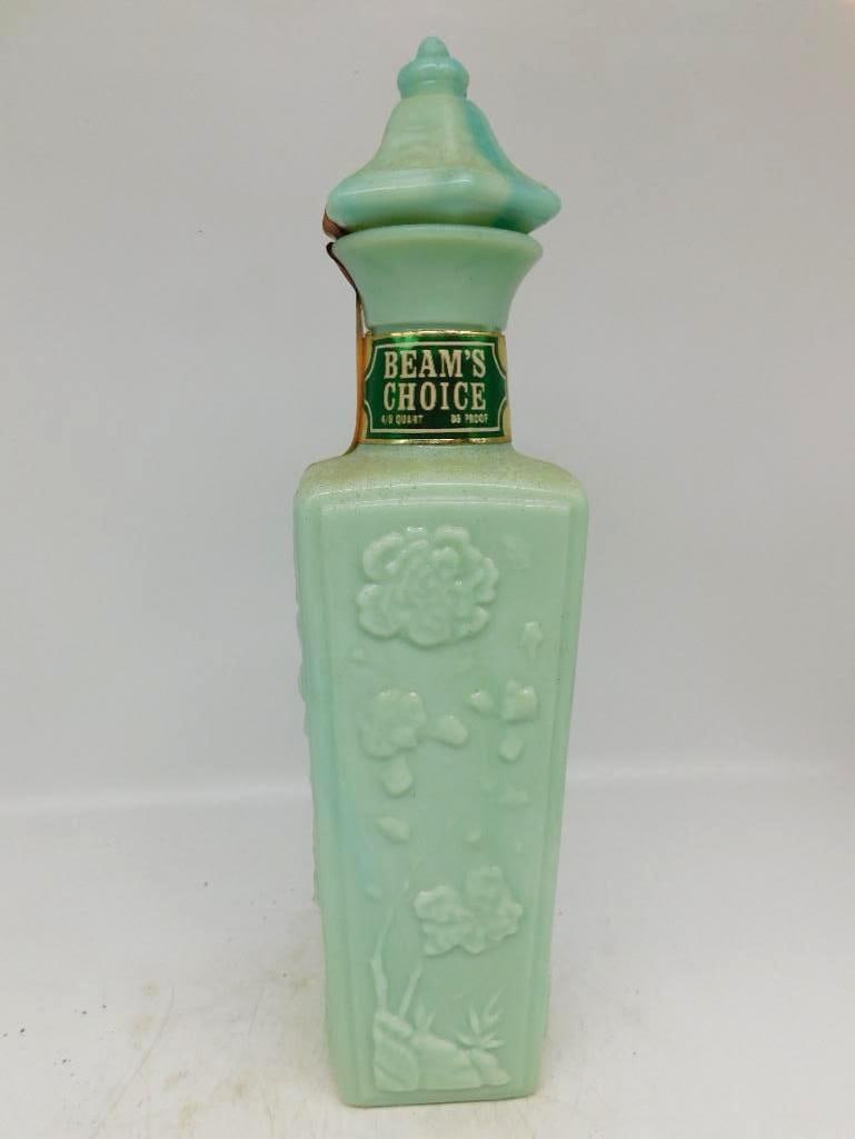 Jim Beam's Choice Jade Green Glass: A trim Beam's Choice decanter in jade-green glass, its panels molded with raised blossoms and slender stems. The stopper repeats the pagoda form of the shoulder, and the color is agreeably soft.