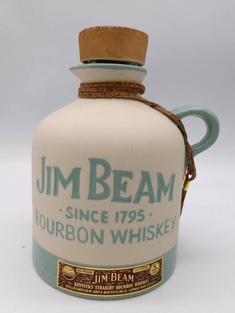 Jim Beam Since 1795 Bourbon Ceramic Jug: A trim ceramic jug decanter by Jim Beam in cream and turquoise, lettered JIM BEAM SINCE 1795 BOURBON WHISKEY across the body. Fitted with a cork stopper and leather tie in the homespun country manner.